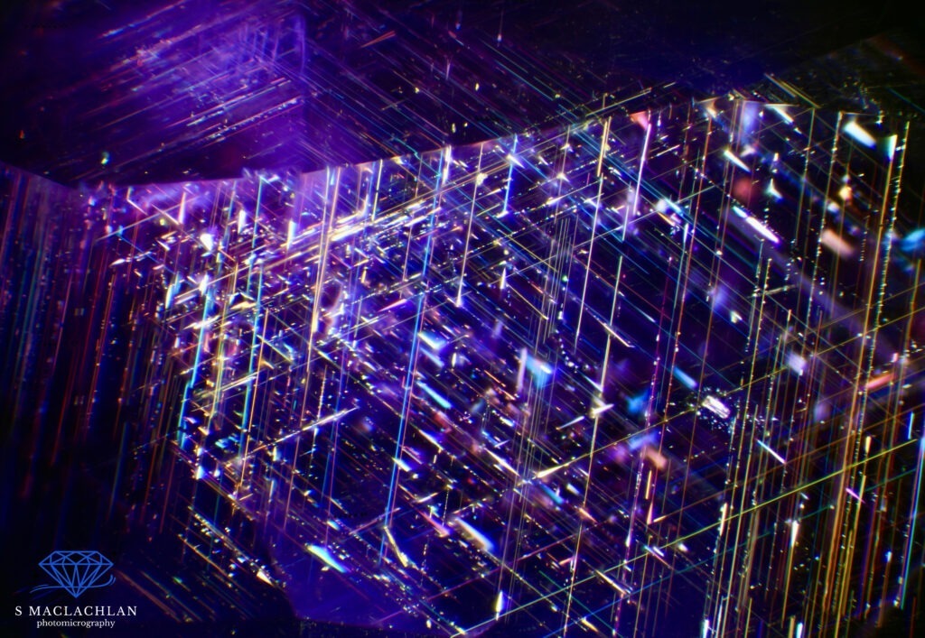 Foto 6: In questa immagine è visibile l’effetto seta in uno zaffiro di colore blu-viola proveniente dallo Sri Lanka. Si tratta di una sovrapposizione di 25 immagini in stacking scattate con un ingrandimento di 120x